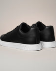 Silvorne black faux leather low top trainers with white soles. Men's casual sneakers with a minimalist design.