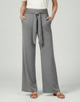 Silvorne grey wide-leg jersey trousers with a tied waistband and pockets, styled casually.