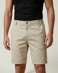 Silvorne men's relaxed fit chino shorts in beige cotton with elastic waist detail and cuffed hems.