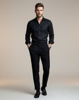 Silvorne Men's black high-waist tailored trousers with a classic waistband and pleated front. Model is wearing a black shirt and dress shoes.