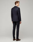 Silvorne men's navy blue 3-piece suit with notch lapel blazer and straight-leg trousers. Model from behind.