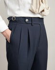 Silvorne men's dark navy textured high-waist tailored trousers with pleats and a gold buckle belt.