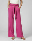 Silvorne women's bright pink wide-leg trousers with a tied waistband and pockets.