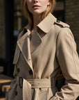 Silvorne beige cotton blend trench coat with double-breasted closure and belted waist.