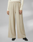 Silvorne women's beige wide-leg trousers with elastic waistband and pleated detail, casual wear.