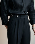 Silvorne Men's black high-waist tailored trousers with pleats and a button-zip closure.