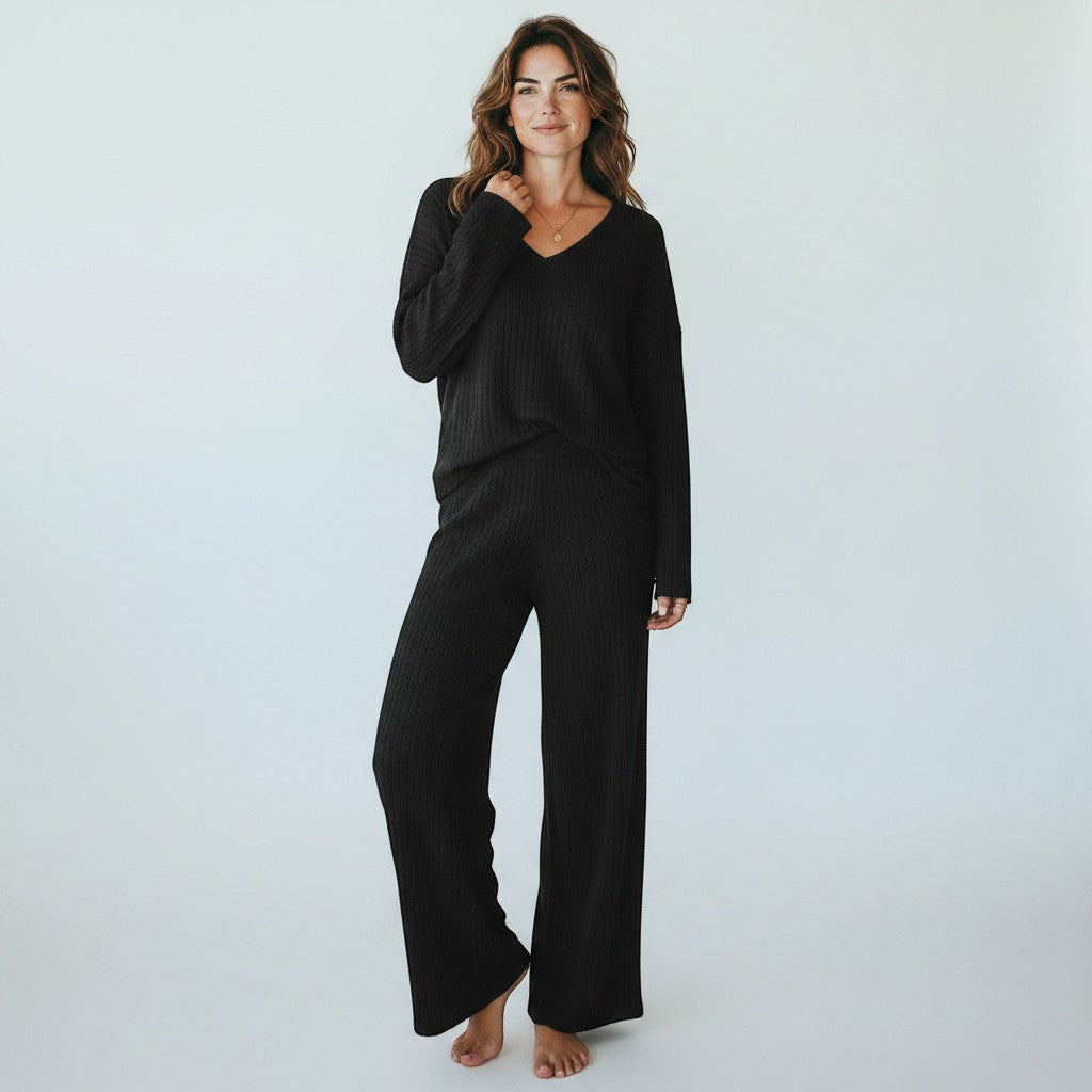 Silvorne black ribbed knit V-neck loungewear set with wide leg pants on a woman.