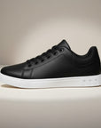 Silvorne black leather-look low top trainers for men with white soles and laces.