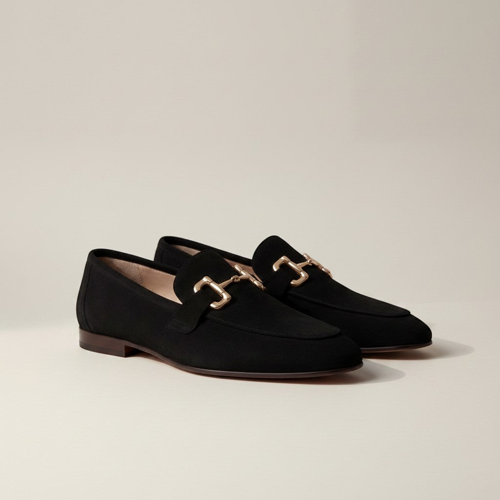 Silvorne black suede loafers with gold horsebit detail and almond toe.