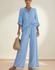 Silvorne light blue linen blend button front blouse and wide leg trousers set on a woman.