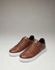 Silvorne men's brown leather-look low top trainers with white soles and black lining.