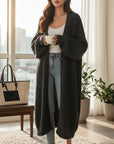 Silvorne cárdigan largo de punto negro de manga larga con bolsillos, ideal para otoño e invierno.