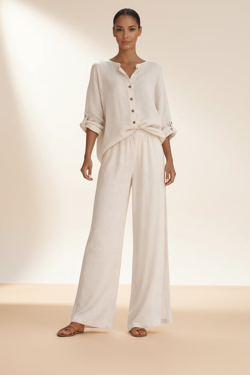 Silvorne cream linen blend button front blouse and wide leg trousers set on a woman.