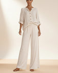 Silvorne cream linen blend button front blouse and wide leg trousers set on a woman.