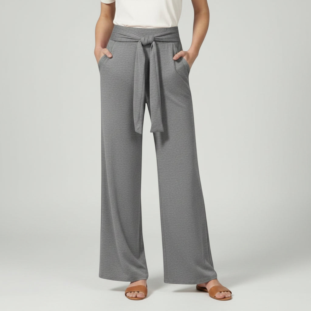 Silvorne grey wide-leg jersey trousers with a tied waistband and pockets, styled casually.