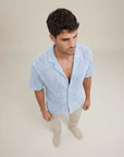Silvorne men's light blue short sleeve knit shirt with open collar and textured pattern, paired with beige trousers.