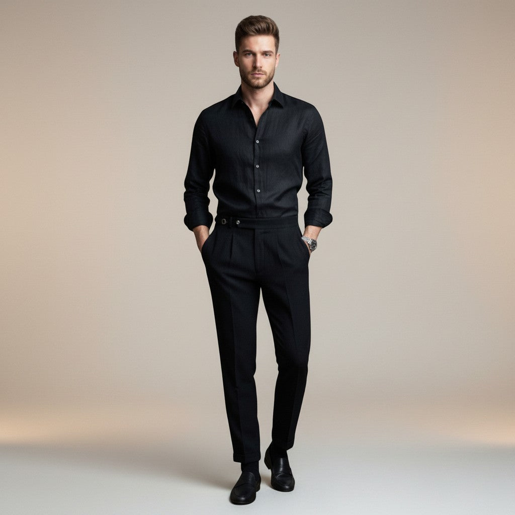 Silvorne Men's black high-waist tailored trousers with a classic waistband and pleated front. Model is wearing a black shirt and dress shoes.