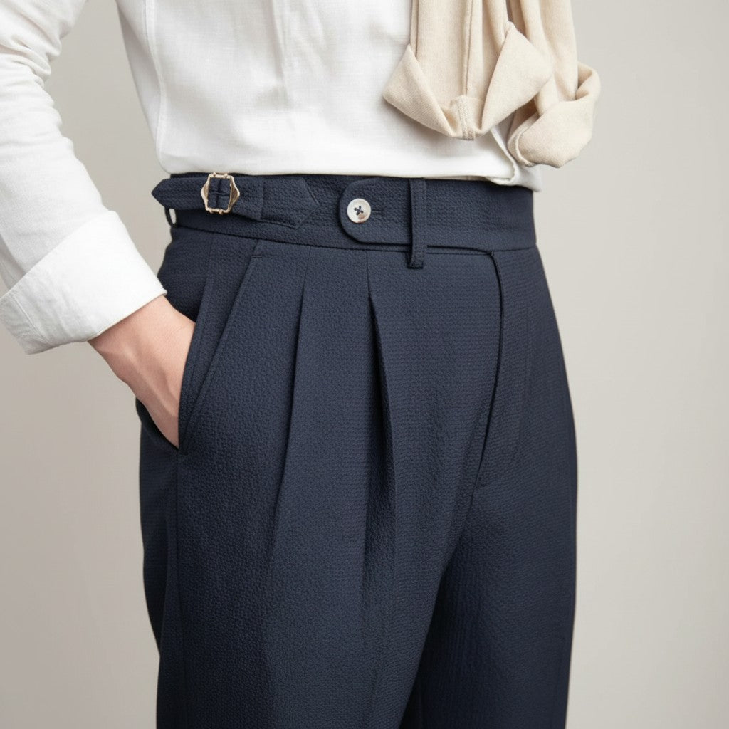 Silvorne men's dark navy textured high-waist tailored trousers with pleats and a gold buckle belt.