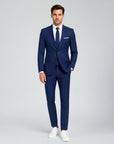 Silvorne men's slim fit royal blue linen suit with white shirt and navy tie. Model wears suit for formal events.