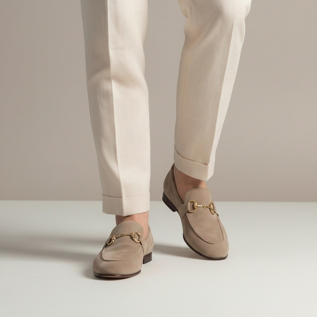 Silvorne men's taupe suede loafers with gold horsebit detail and almond toe. Styled with cream trousers.
